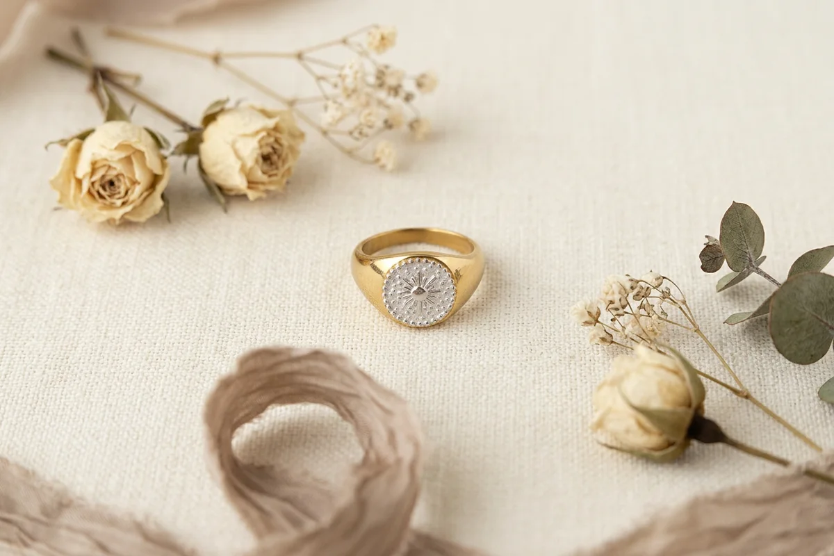 Waterproof two-tone gold and silver jewelry on a linen background